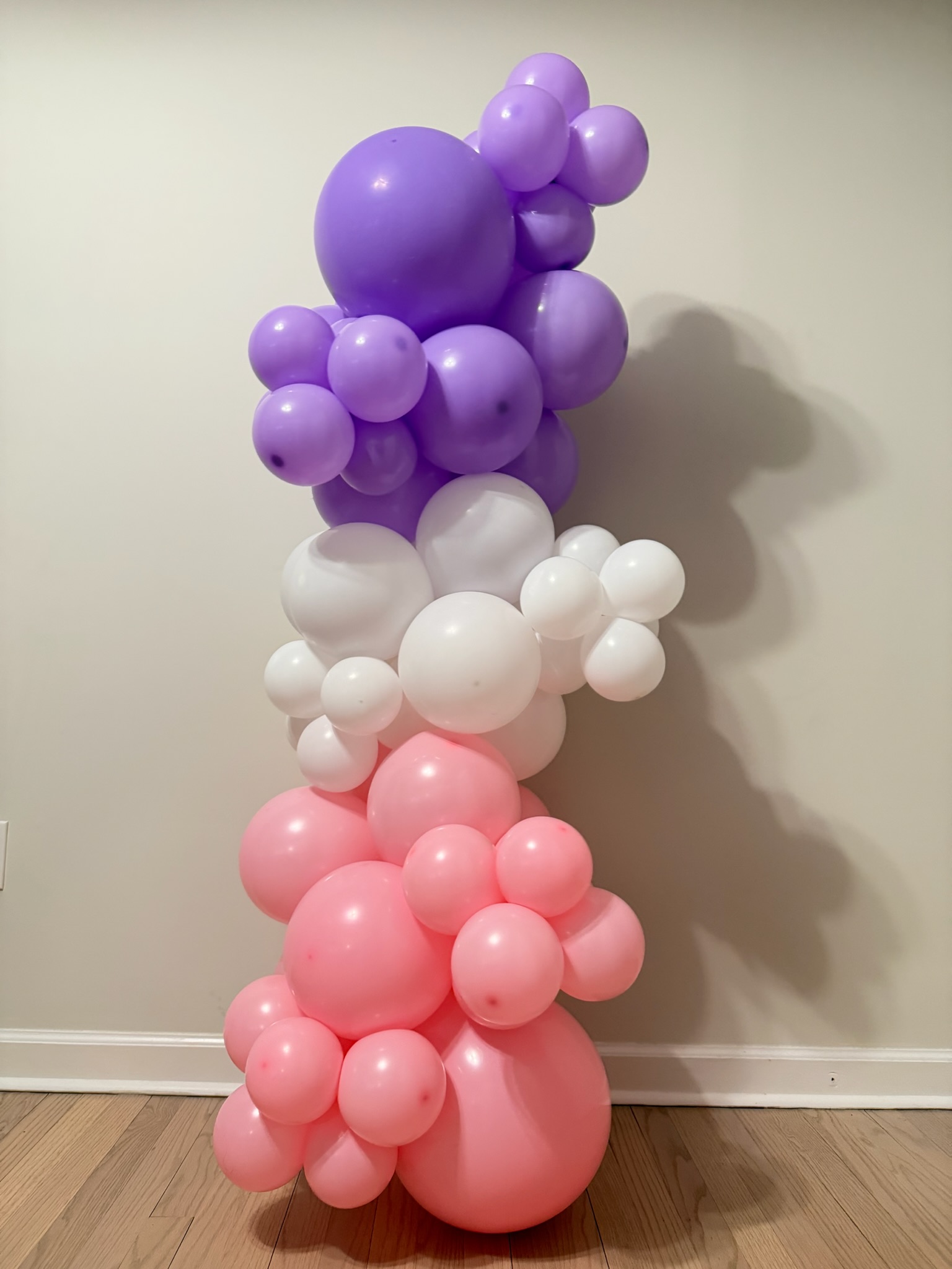 Ombré balloon column in purple, white and pink