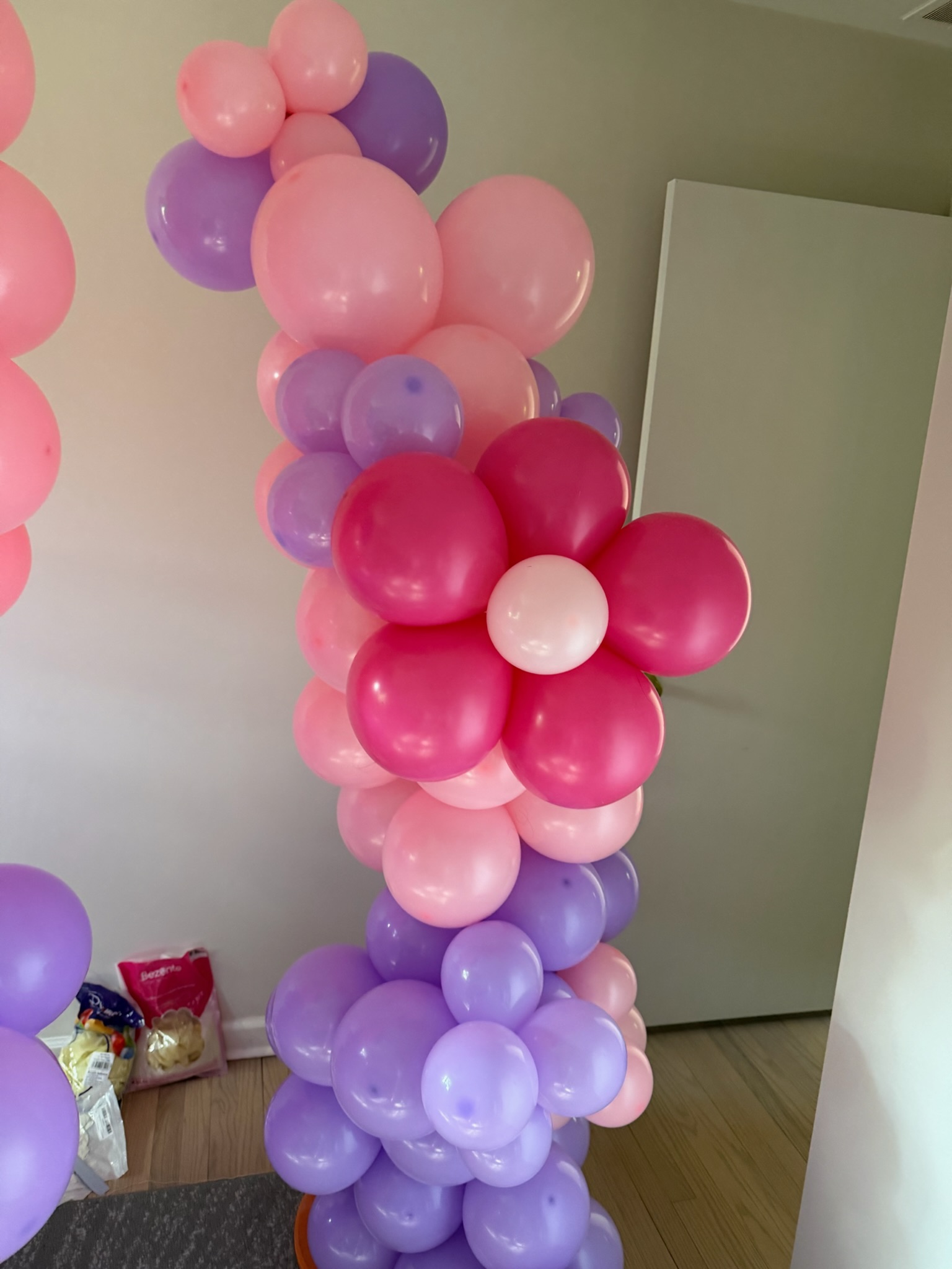 Pink and purple organic balloon column with flower