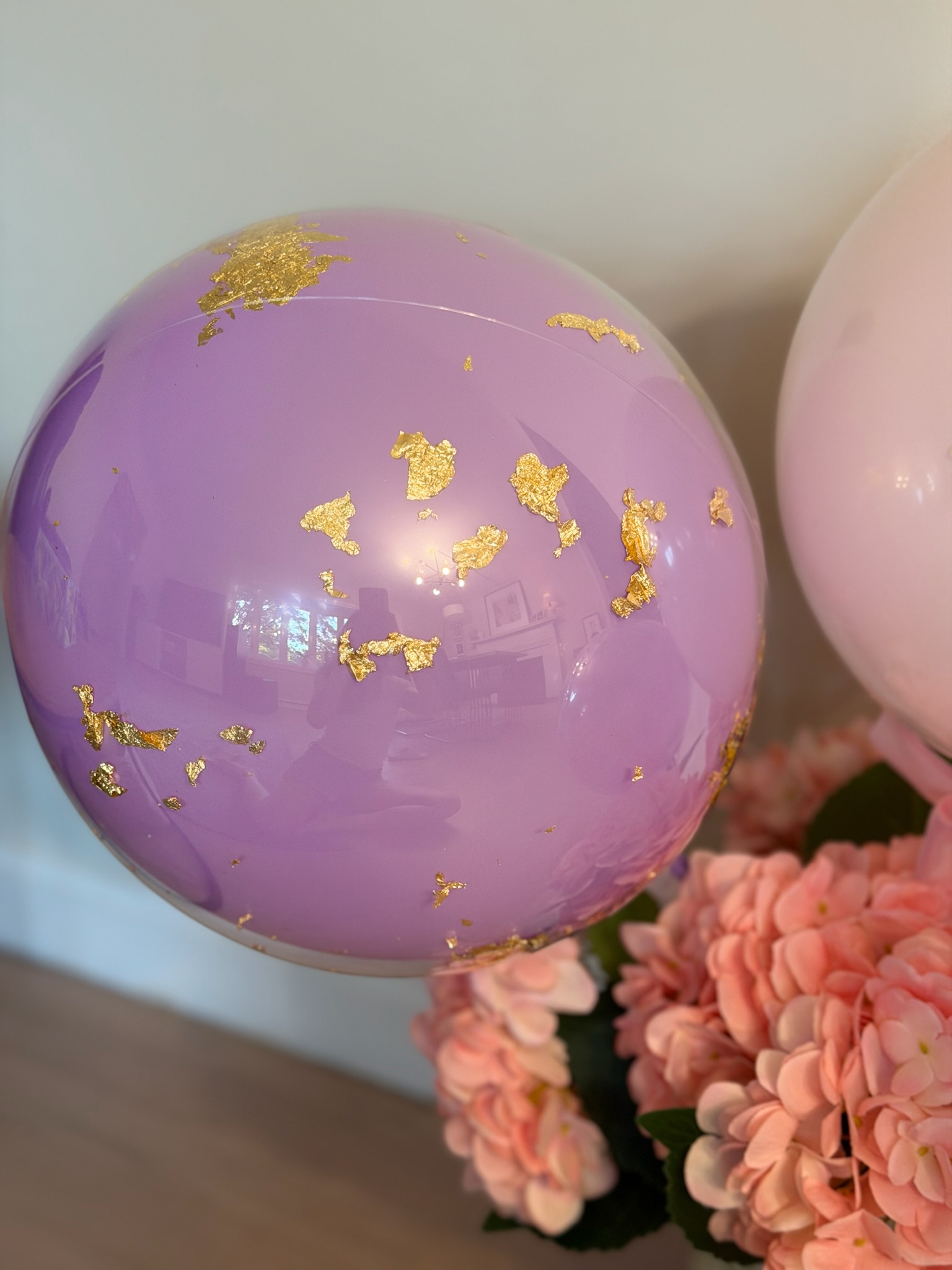 Close-up of purple helium balloon with gold leaf detail